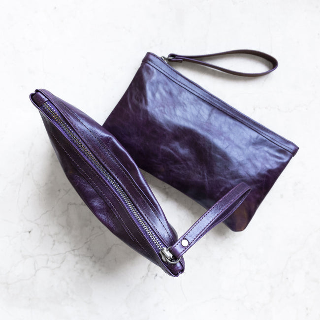 aubergine | alex wristlet clutches, size medium shown, in aubergine, one laying flat and one standing to show top zipper