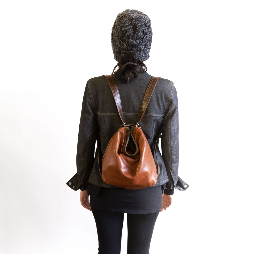 Model wearing a hobo pack open pocket as a backpack, in size small, for size demonstration. The size of the hobo pack open pocket is approximately the same as the city safari original. 