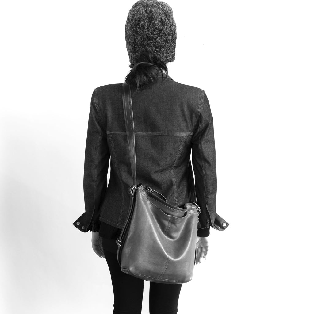 Model wearing a small hobo pack open pocket crossbody. The size of the small hobo pack open pocket is approximately the same as the small original city safari single zip. 