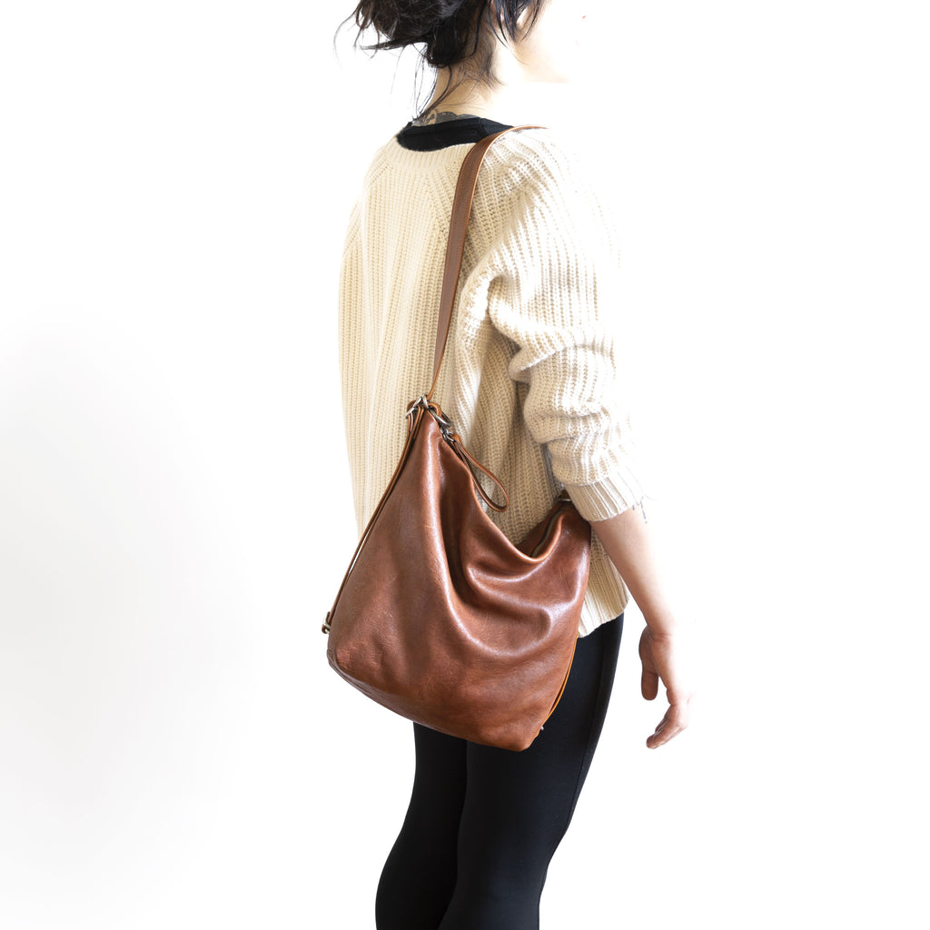 Model with a hobo pack original, size small, showing strap adjusted to shoulder length. 