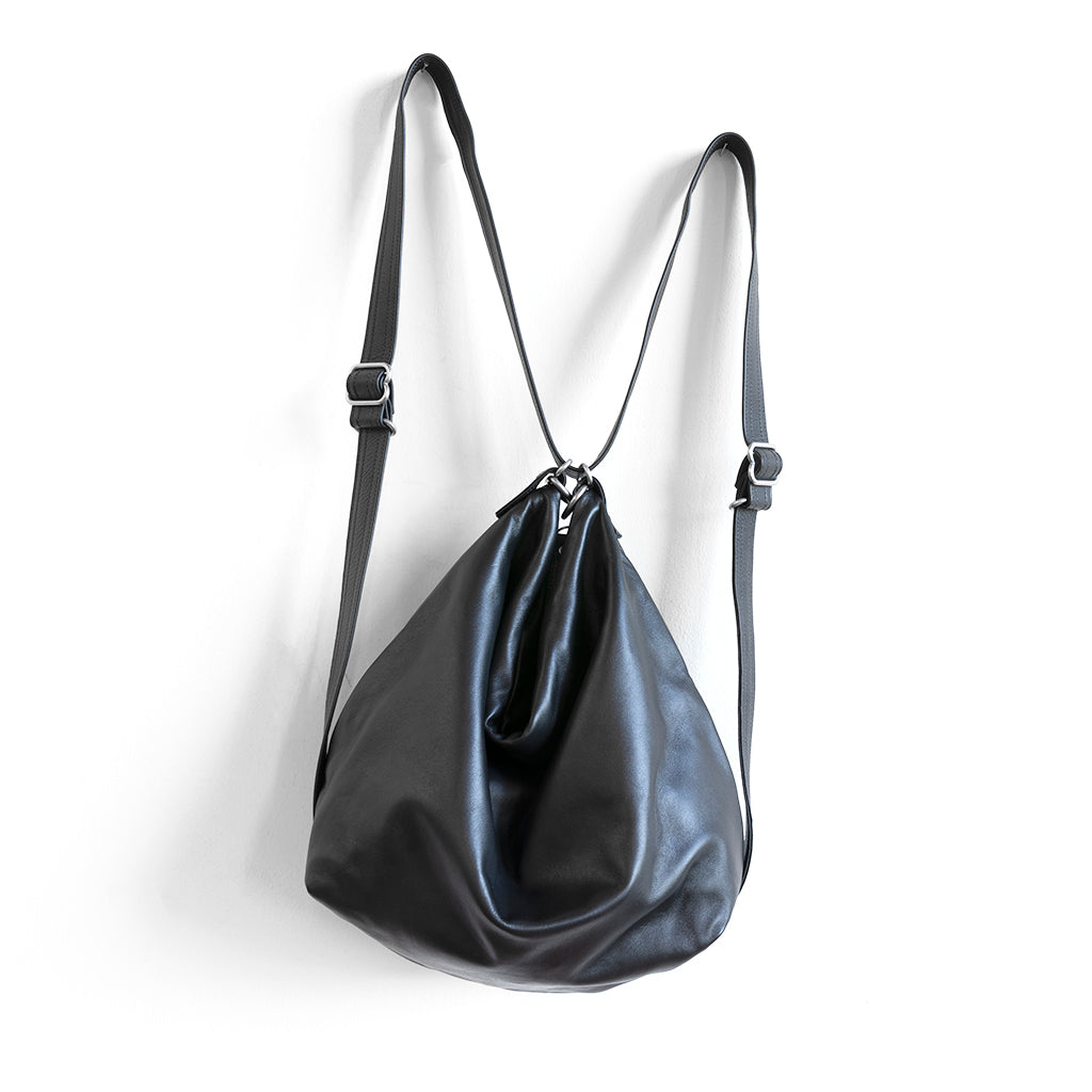 hobo pack original in plonge black with black, low-profile strap adjusted as a backpack