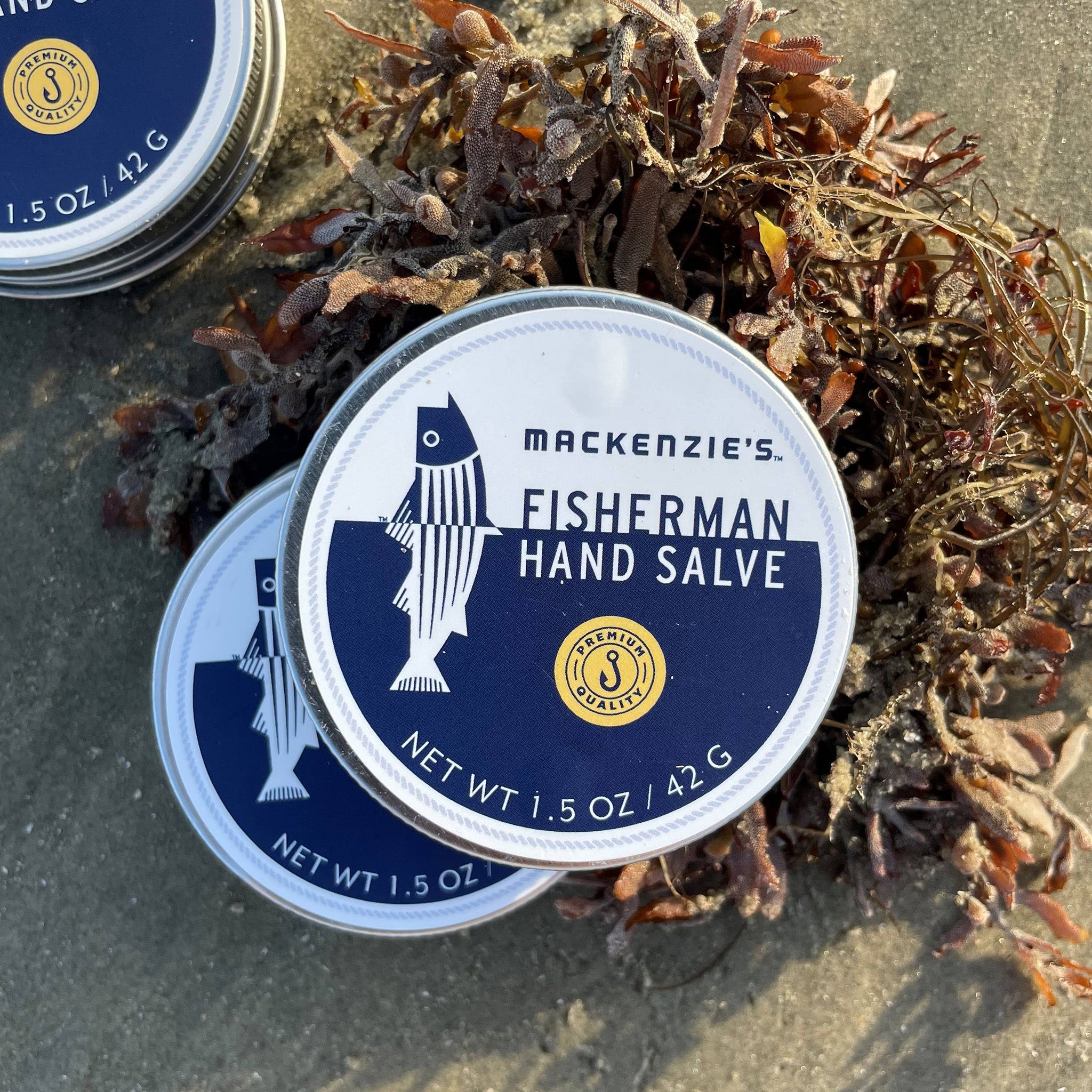 fisherman hand salve tin on beach