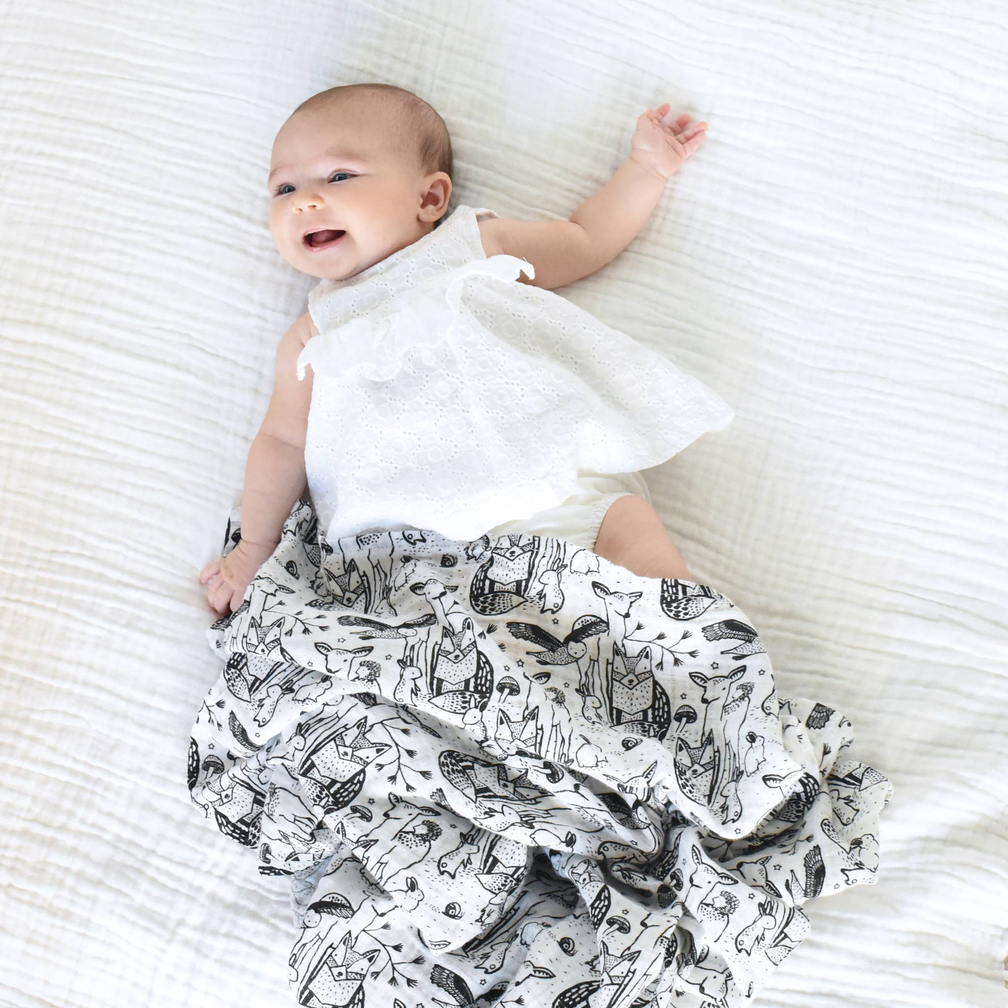 organic muslin swaddle forest  on baby