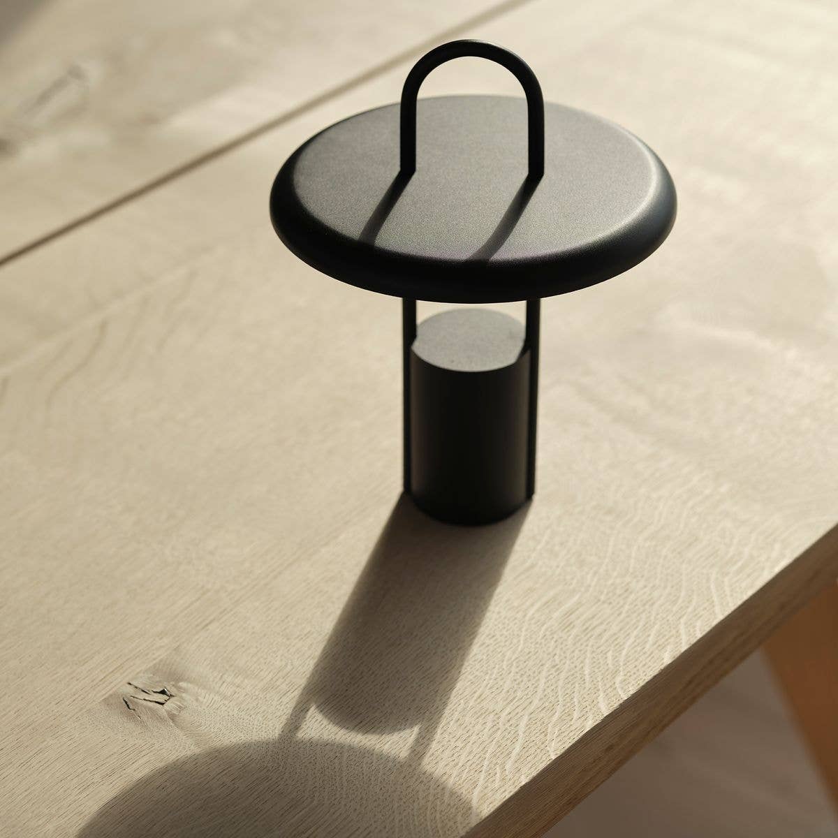 pier LED lamp - black (614) by stelton on table