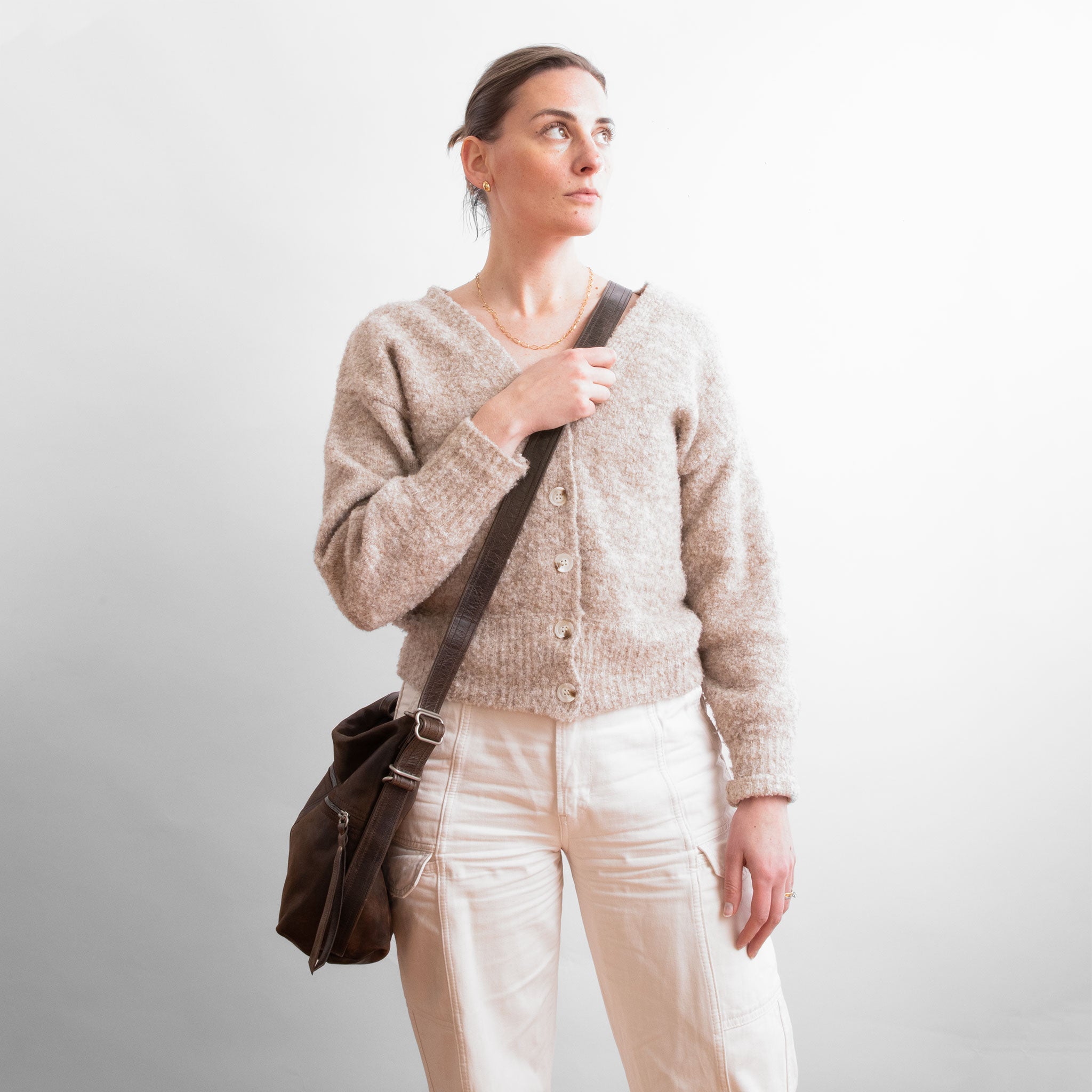 model wearing small city in distressed espresso as crossbody style