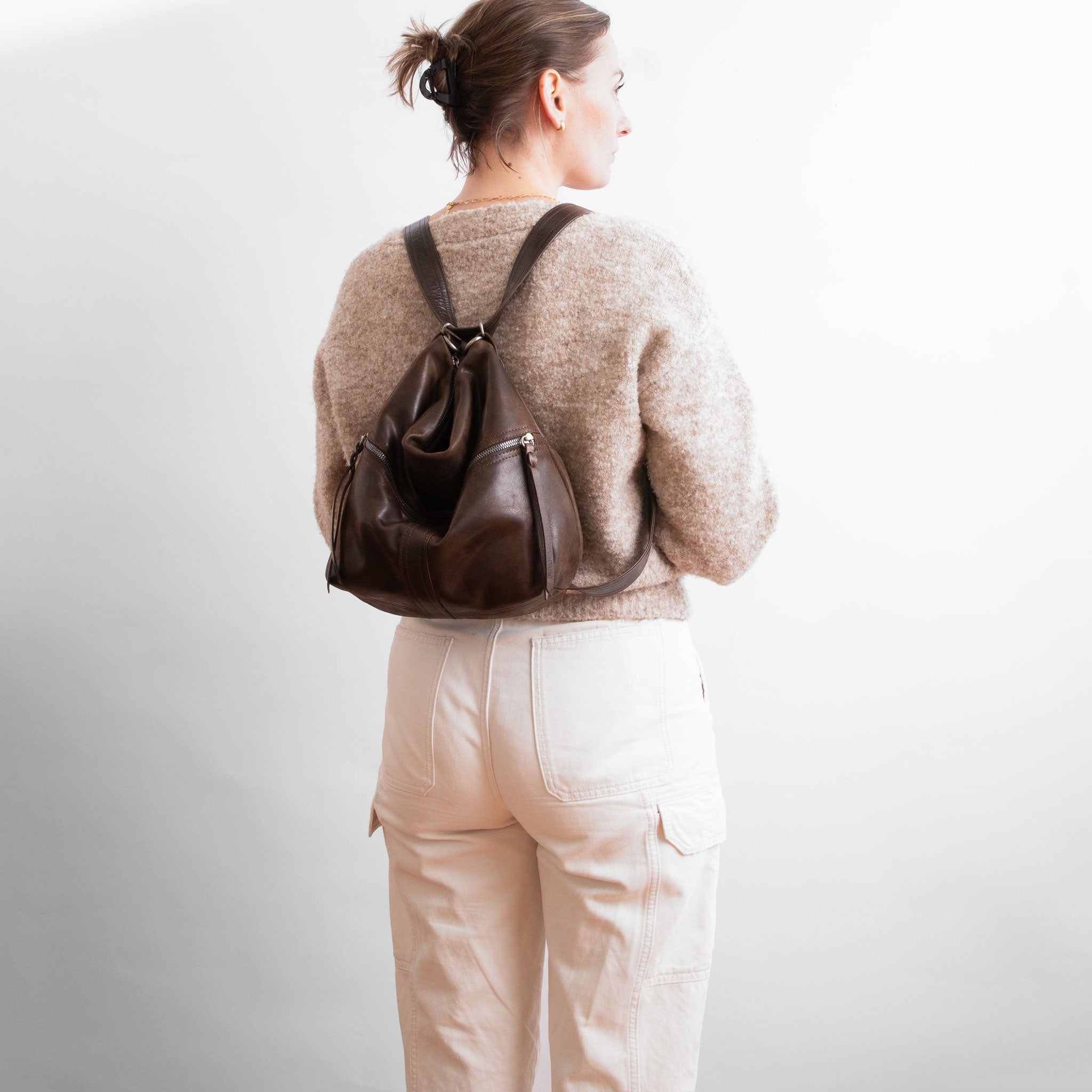 model with original city safari in distressed espresso and rustic pecan worn as a backpack