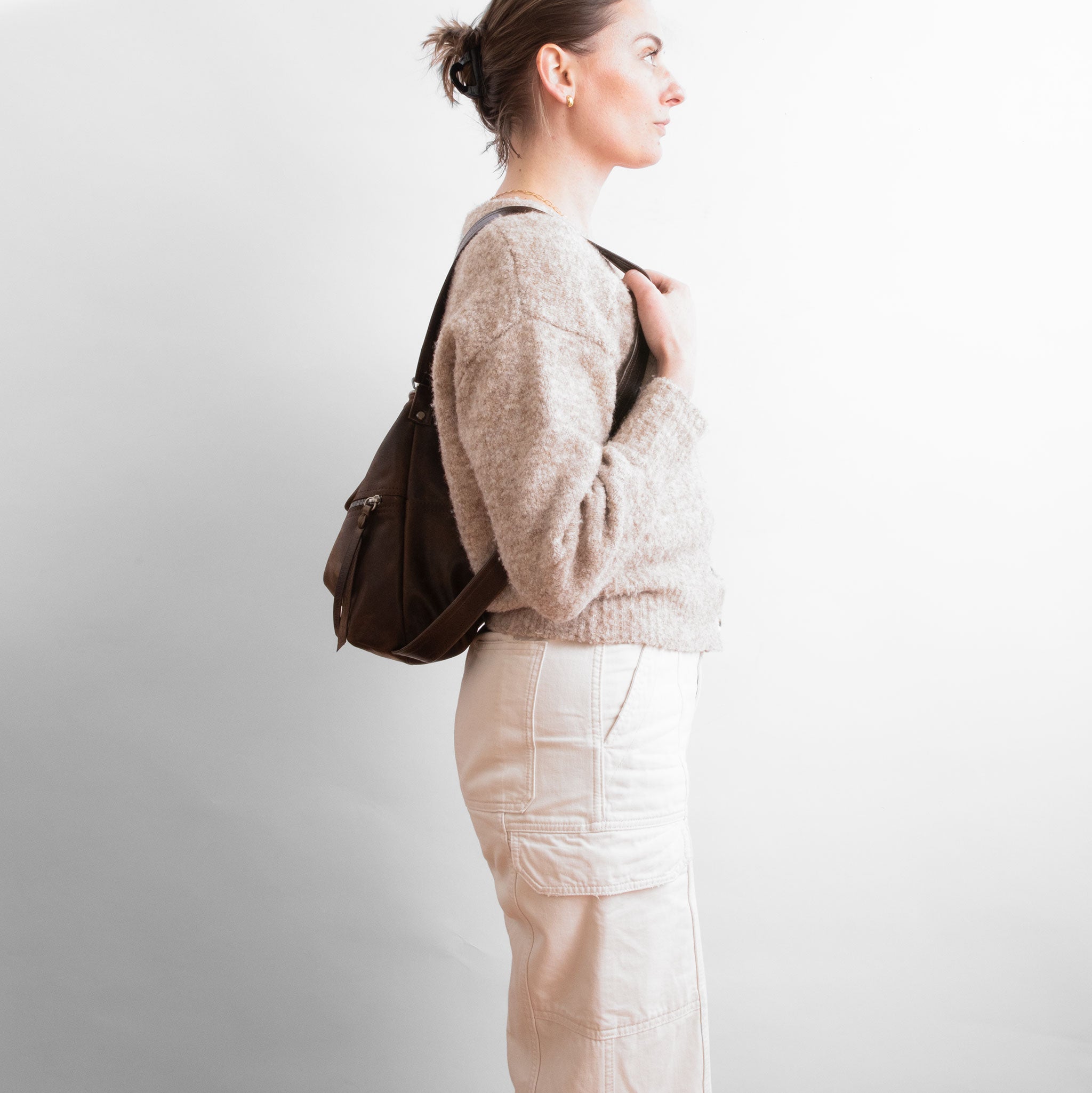 model with original city safari in distressed espresso and rustic pecan worn as a backpack