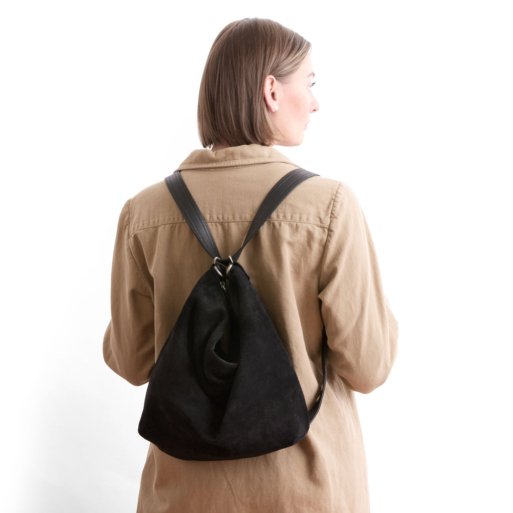 model wearing large hobo, black suede, in backpack 