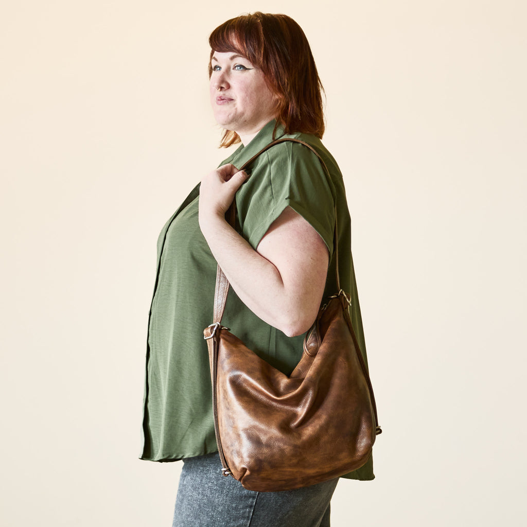 Model with a hobo pack original, size large, showing strap adjusted to shoulder length. 