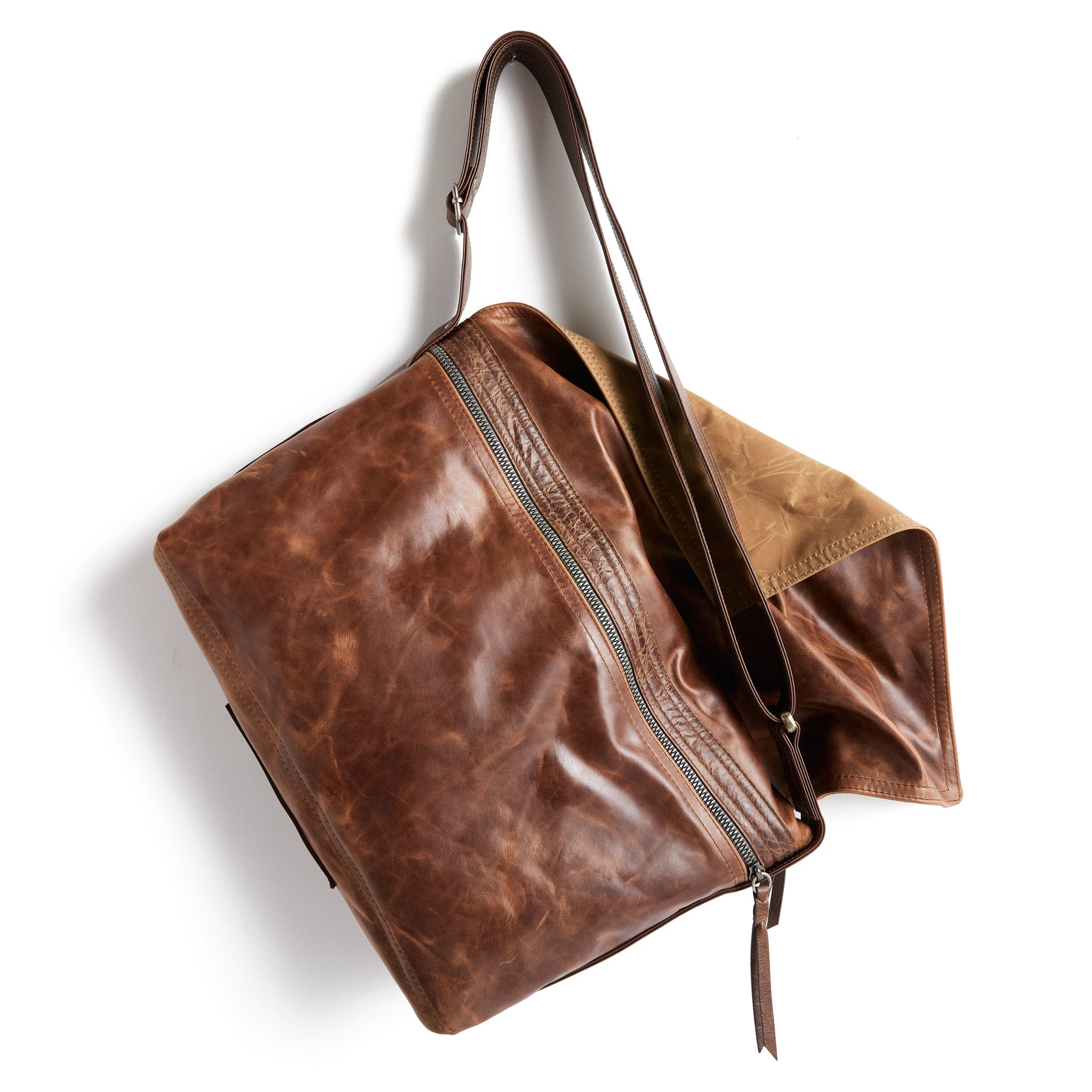 zip top messenger in selkie, showcasing back exterior zippered pocket