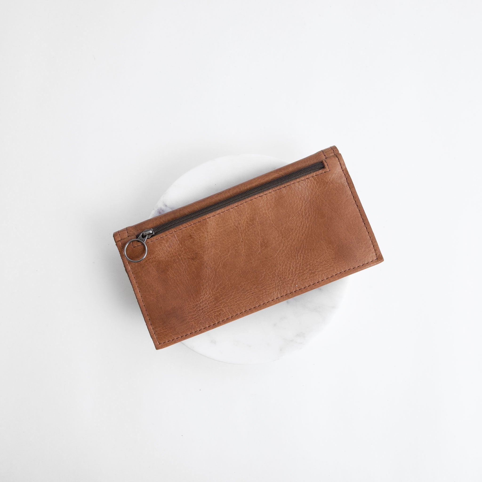 snap wallet in premium saddle, showcasing back zippered pocket