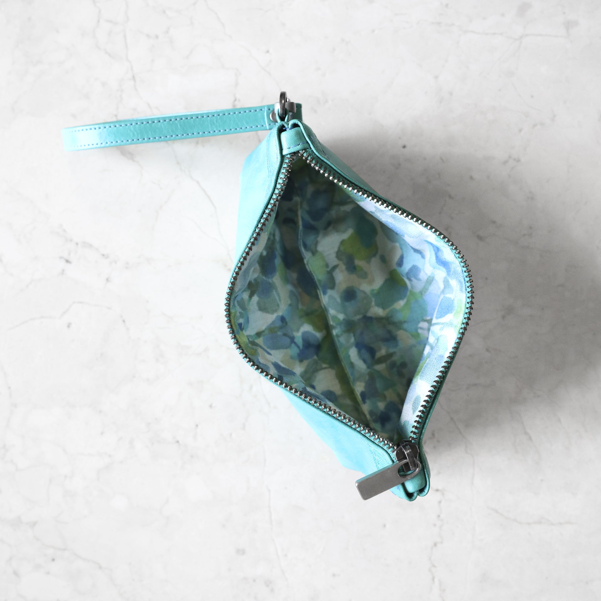 interior view of zip pouch with top stripe medium in pool with petal party blue lining (this lining is different from current variant)