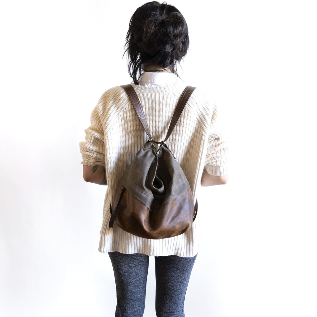 Model wearing an original city safari single zip, size large, as a backpack. 