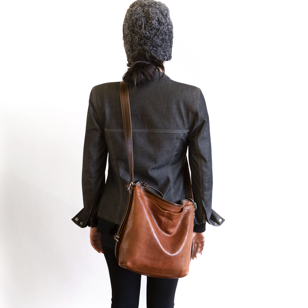 Model wearing a hobo pack original crossbody, in size small, for size demonstration. The size of the hobo pack open pocket is approximately the same as the city safari original. 