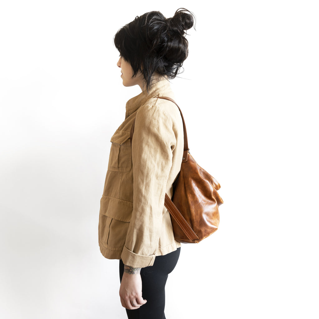 Model with a hobo pack original, size large, showing strap adjusted for backpack carry. 