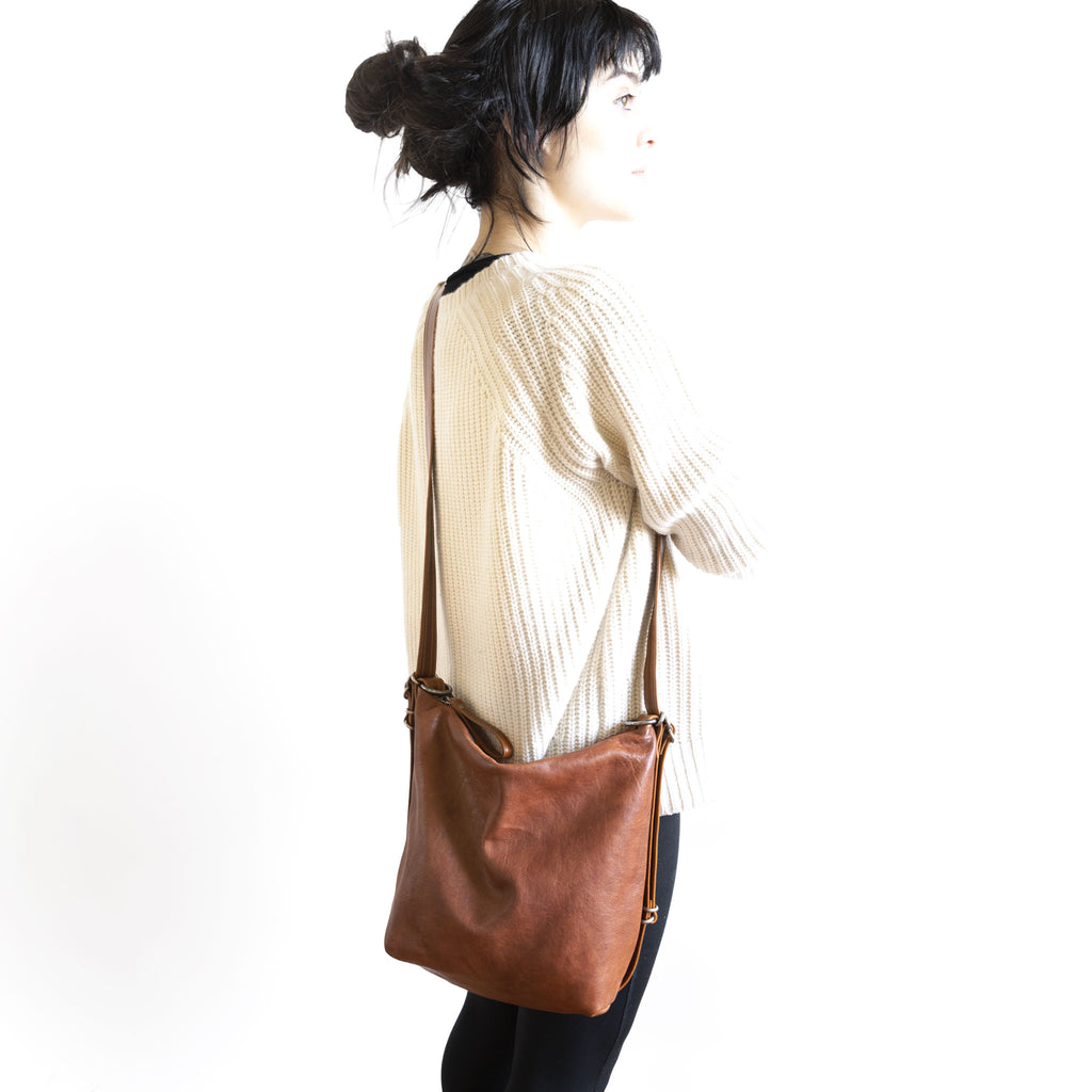 Model with a hobo pack original, size small, showing strap adjusted to crossbody length. 